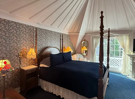 The Shaw Suite — vaulted ceilings, fireplace, and antique furnishings